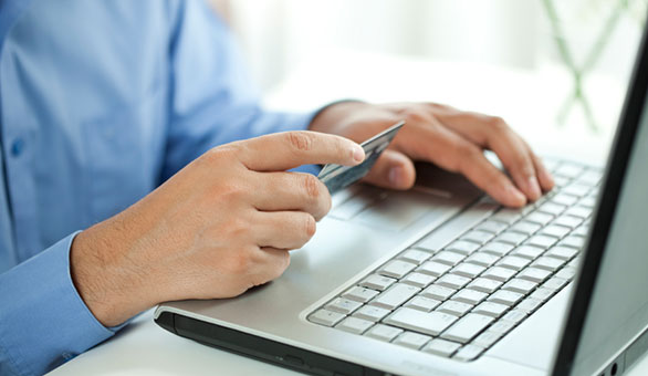 Man with a Credit Card and Laptop